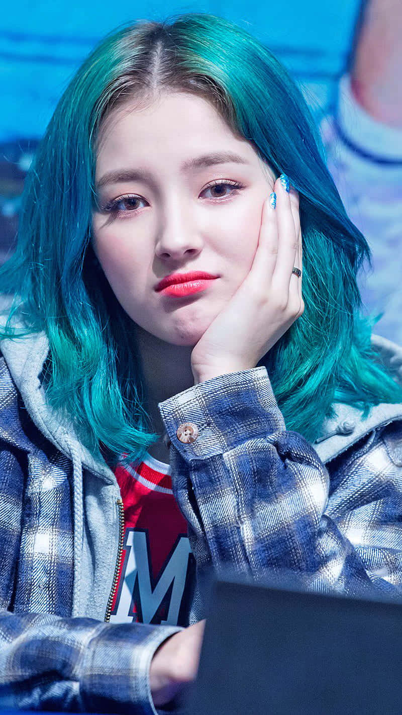 Teal Haired_ Woman_ Resting_ Chin_on_ Hand Background