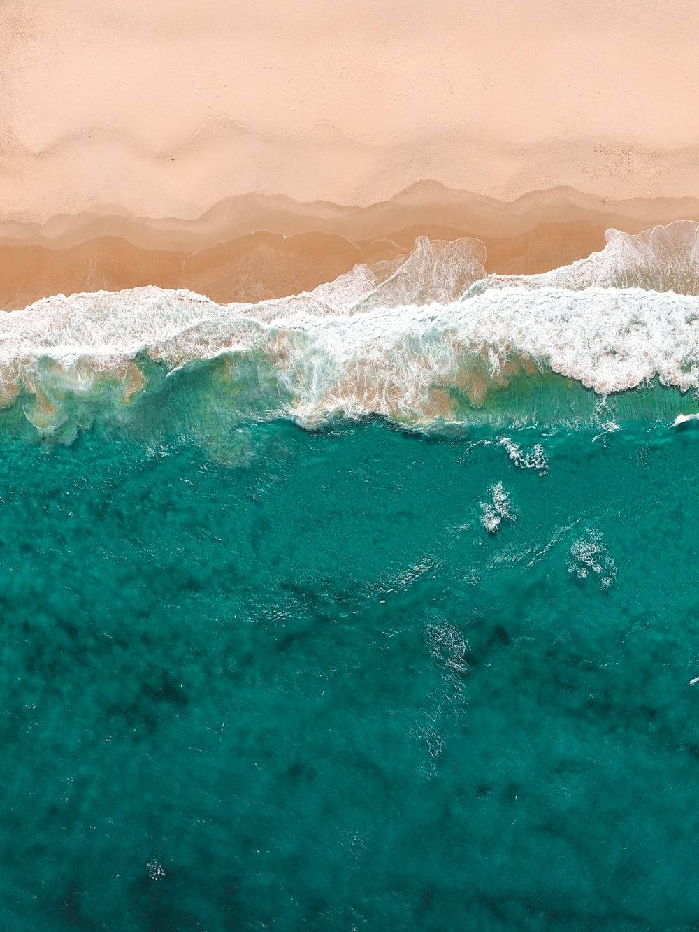 Teal Ocean Waves And Sand Background