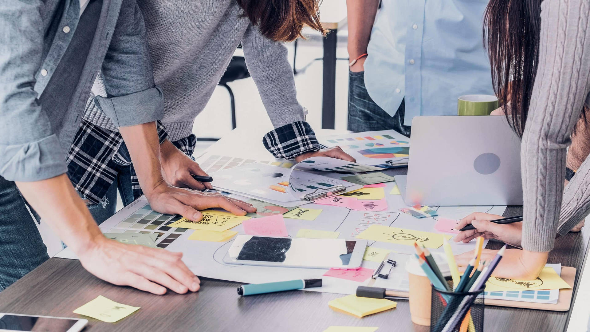 Team Brainstorming For Content On Messy Desk Background