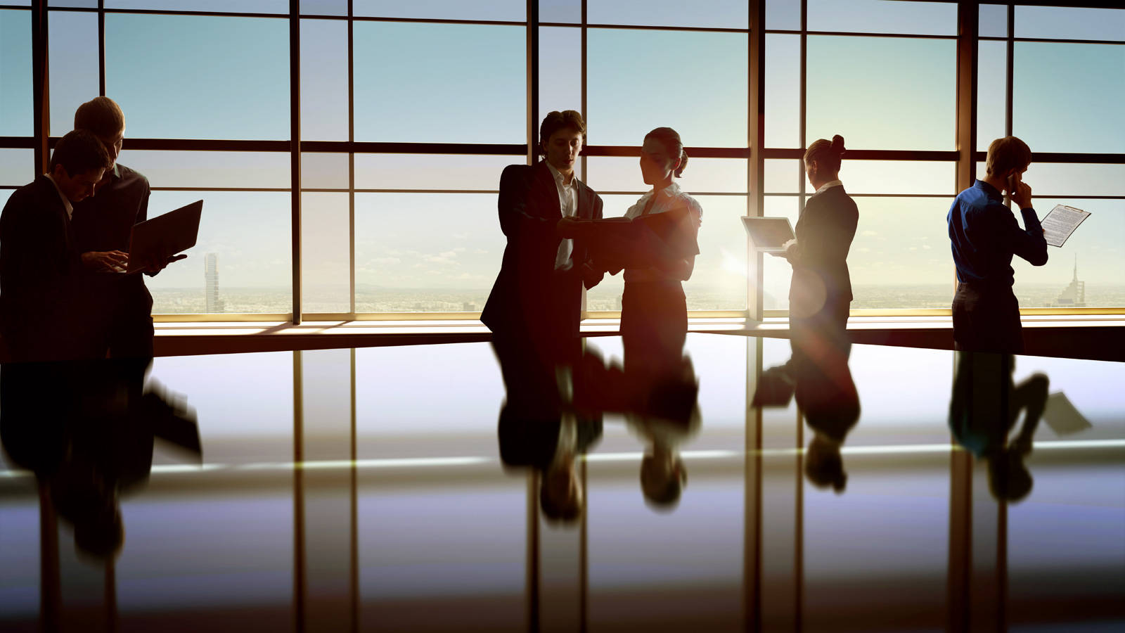 Team Discussing Work During Sunset Background