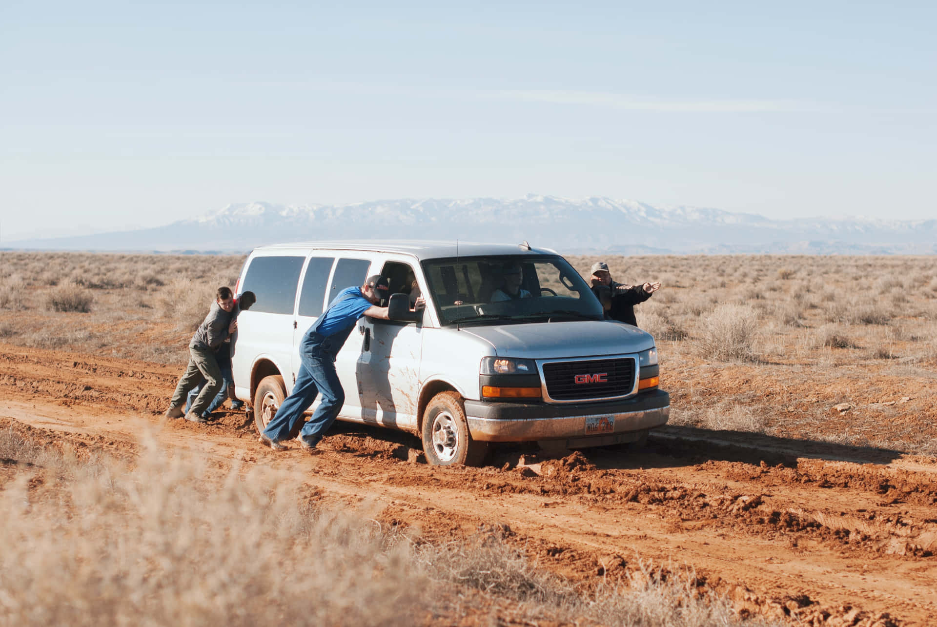 Teamwork In Adversity - Men Pushing A Stranded Car
