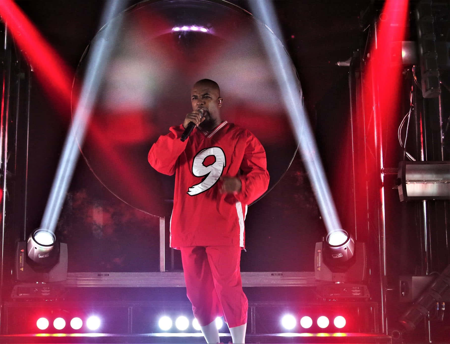 Tech N9ne Performing Liveon Stage Background