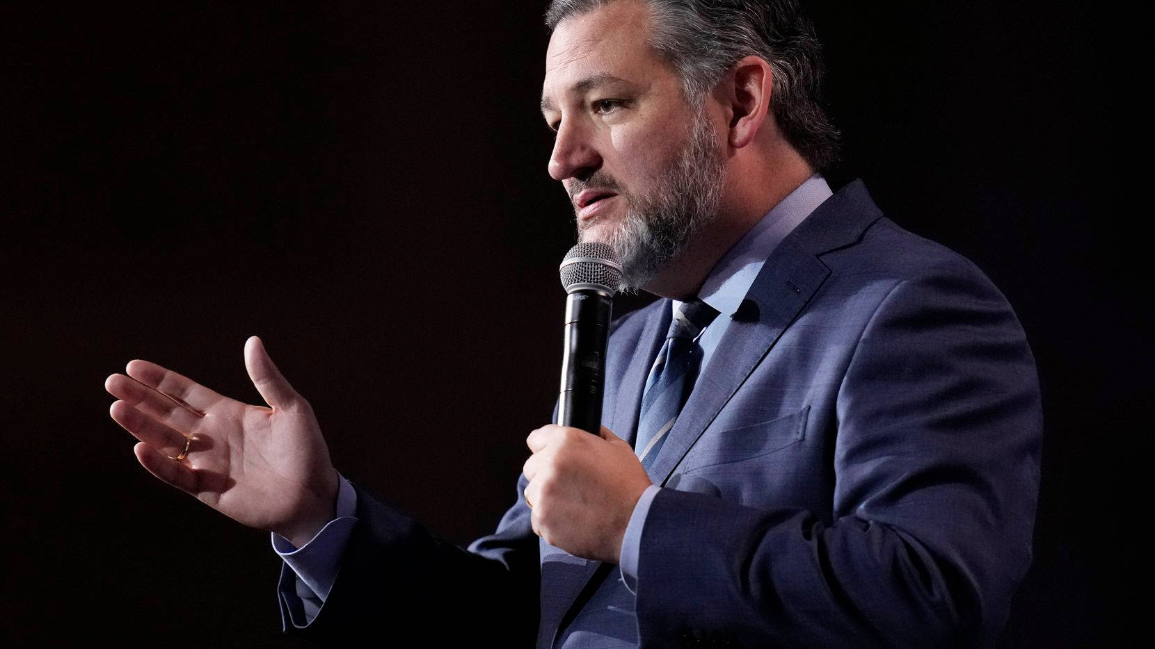 Ted Cruz Speaking On Stage Background