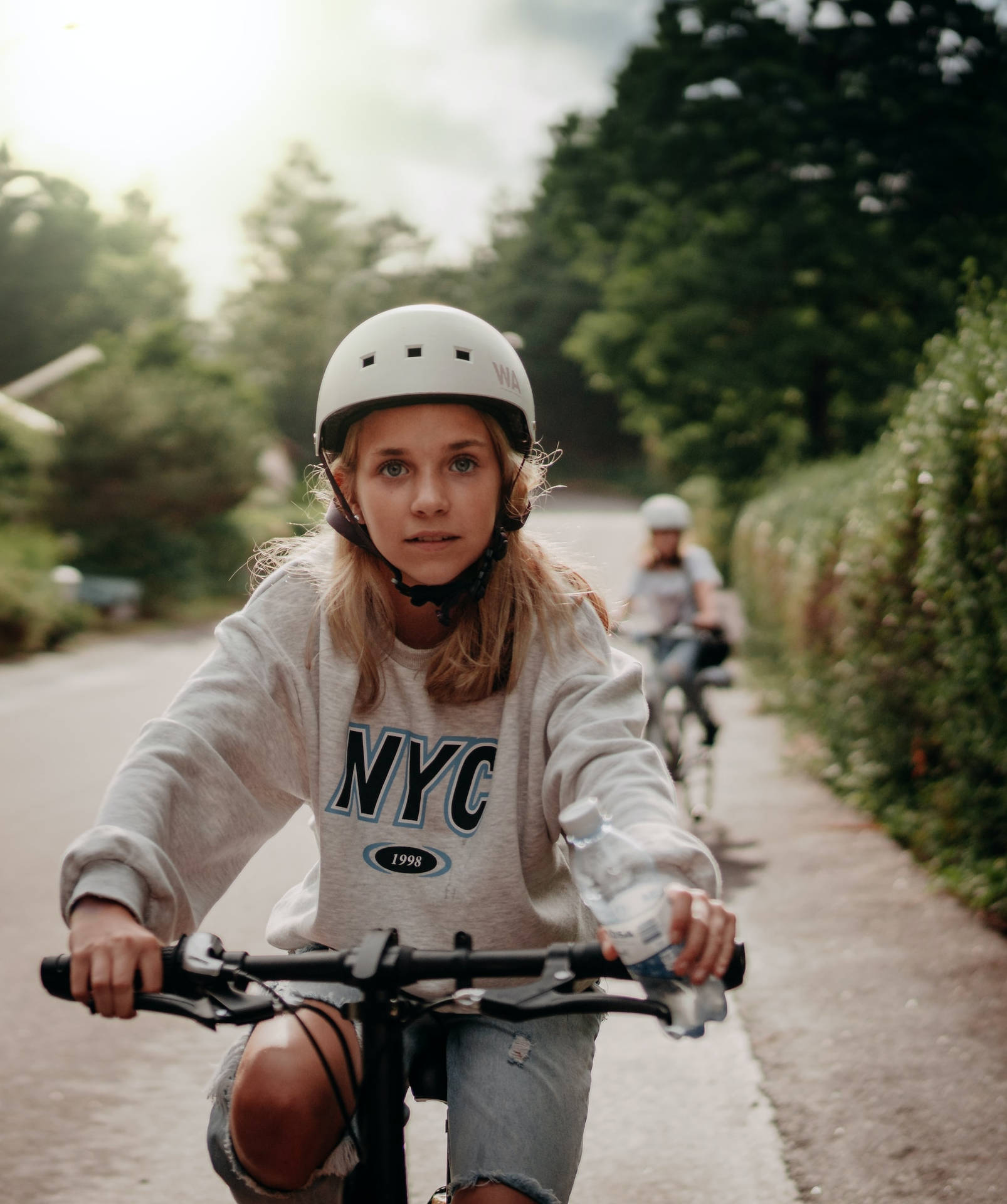 Teenage Blonde Girl Riding Bicycle Background