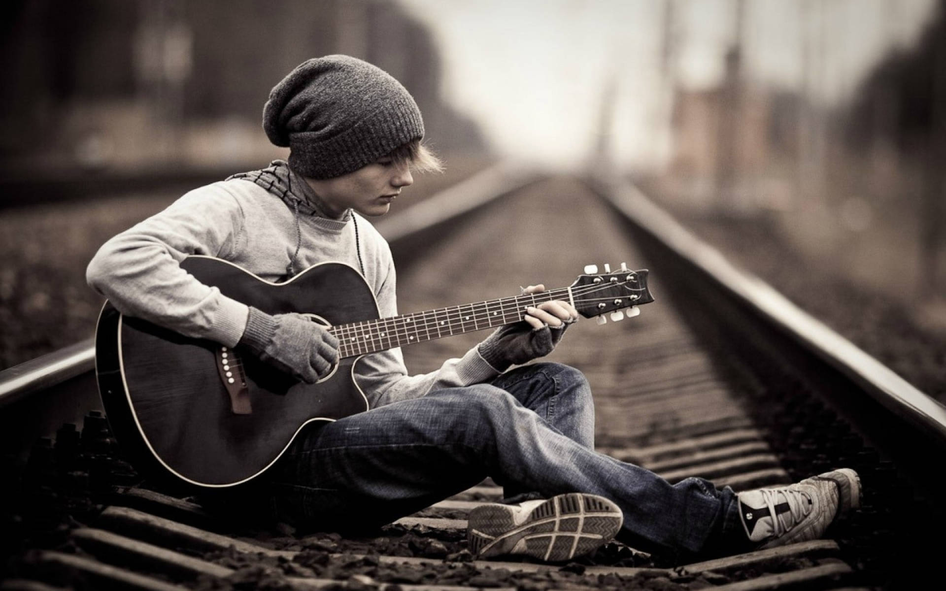 Teenage Boy Standing Alone On A Railway Track