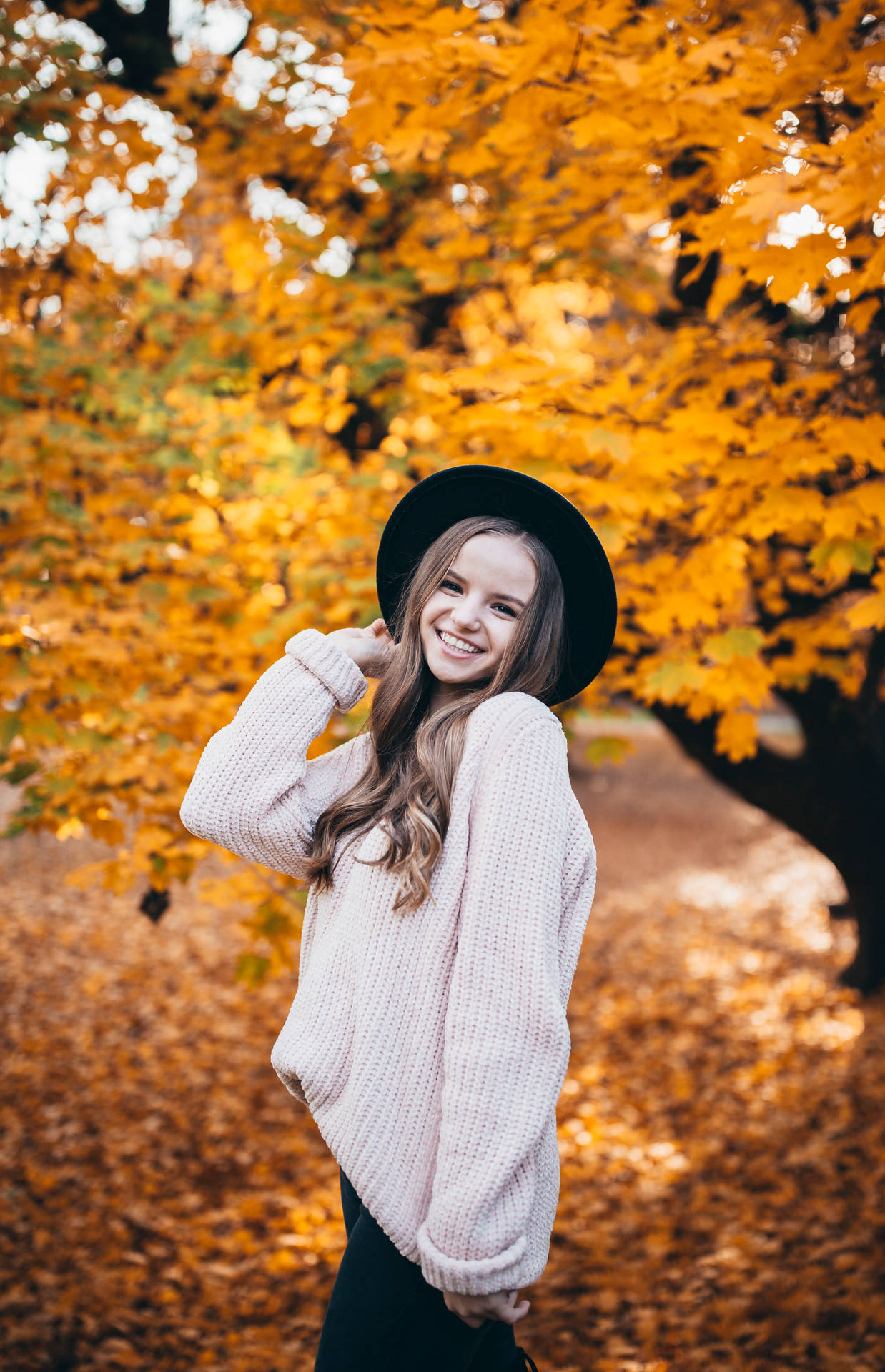 Teenage Girl By Autumn Tree Background