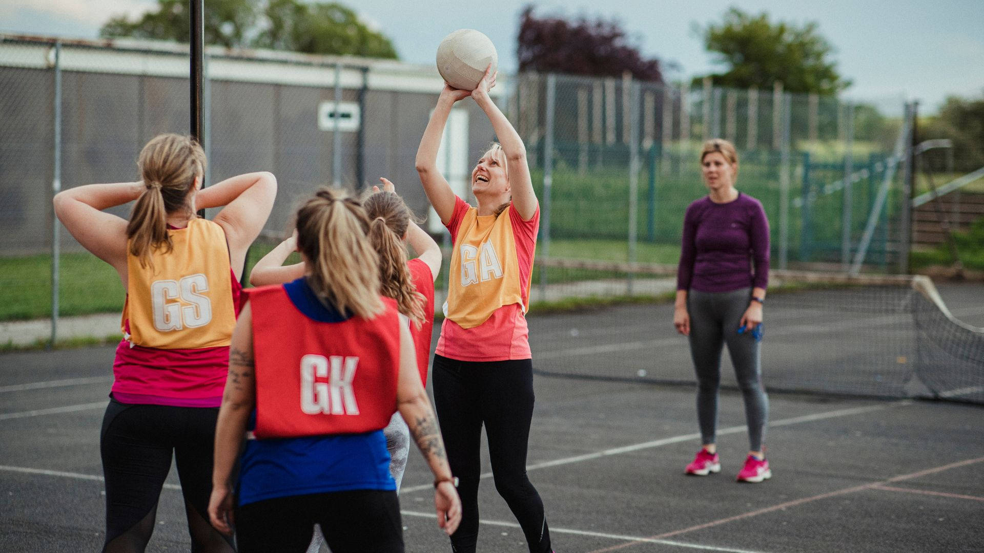 Teenage Girl Preparing To Score A Netball Goal