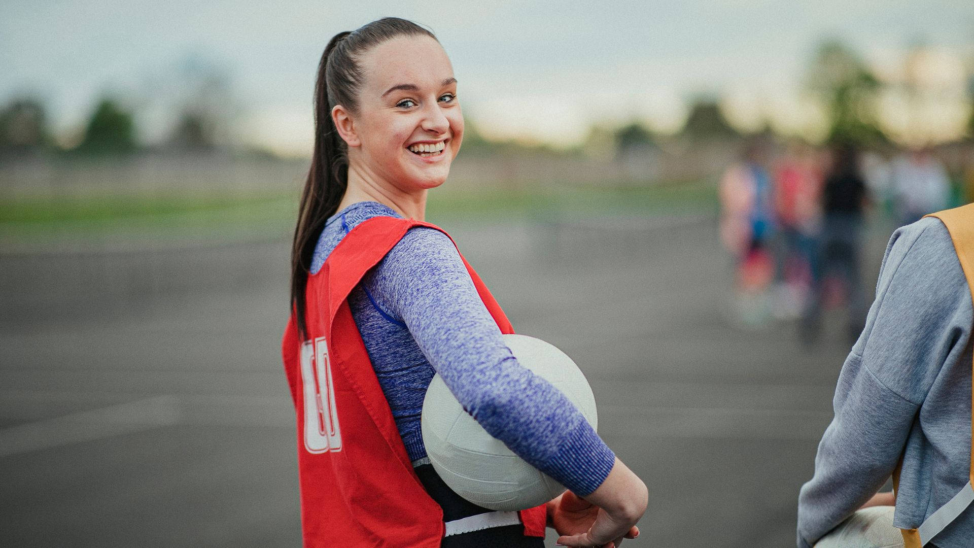 Teenage Girl Smile Playing Netball Background