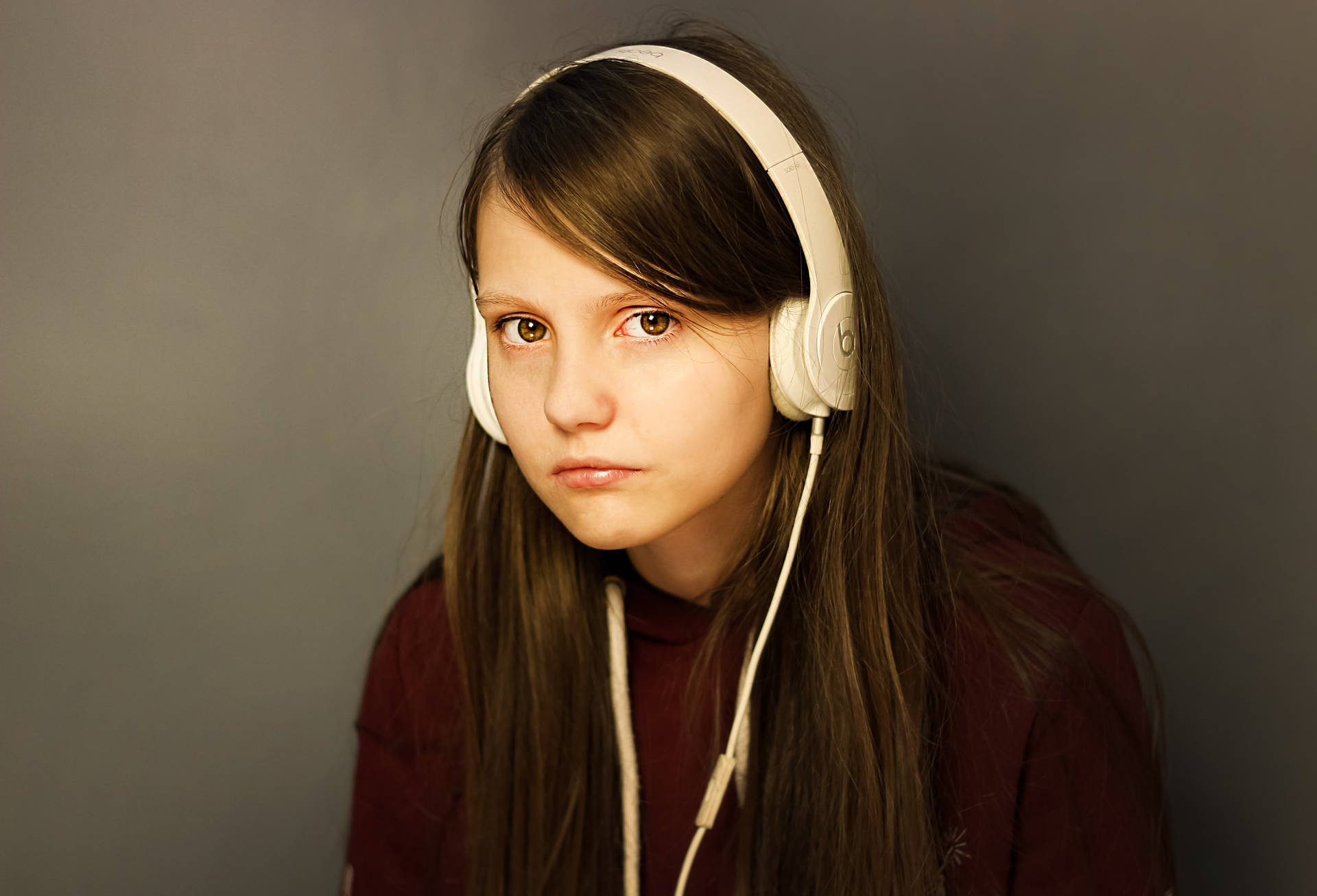 Teenage Girl White Headset And Maroon Sweater Background