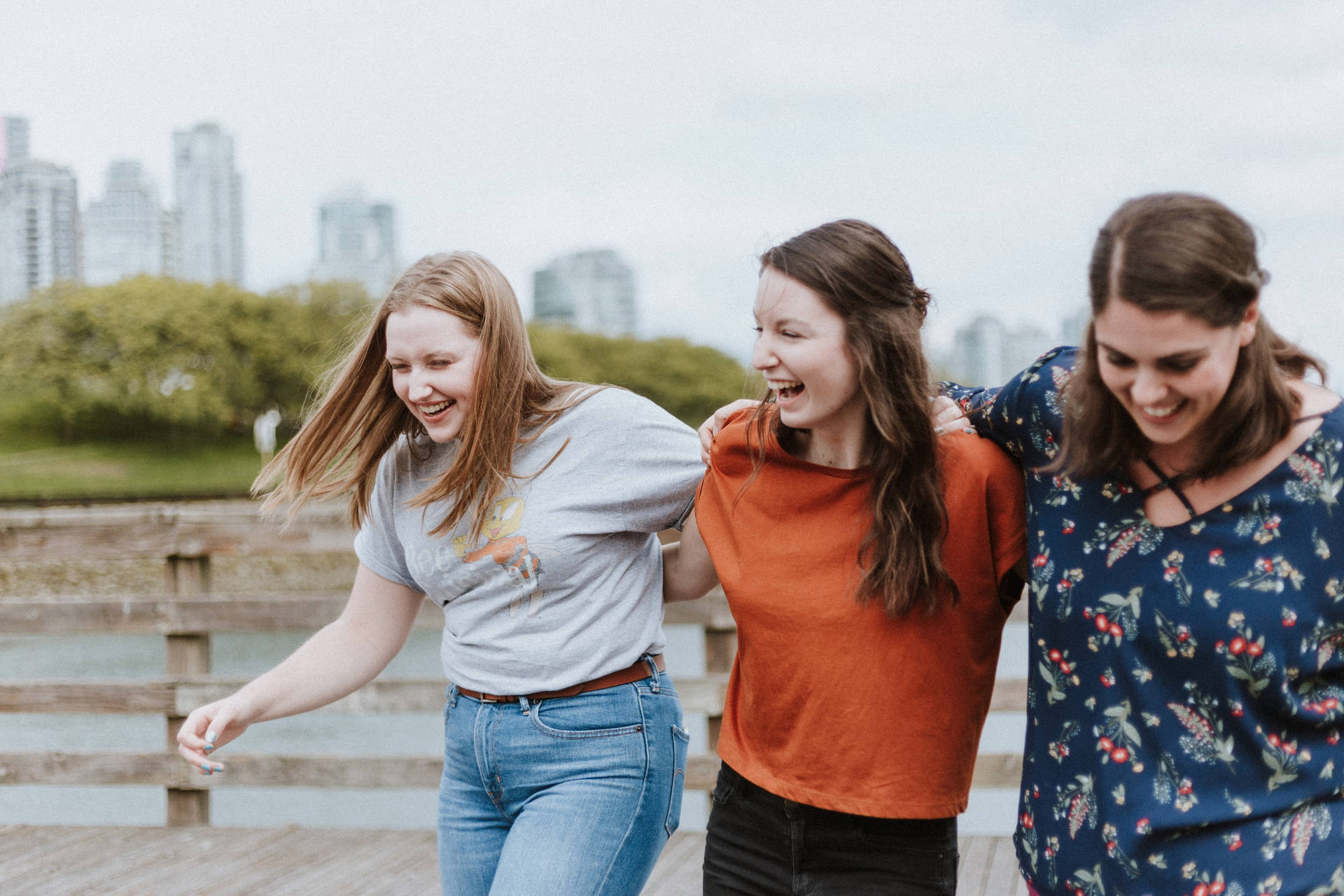 Teenage Three Girls Walking And Laughing Background