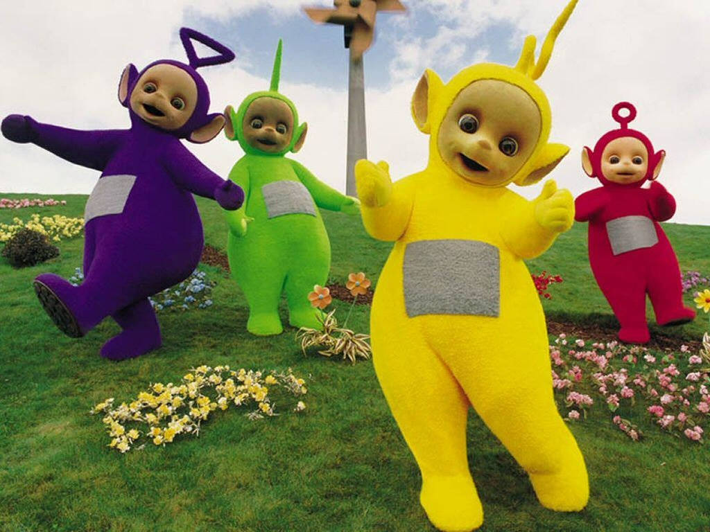 Teletubbies Danicng On Flower Field Background