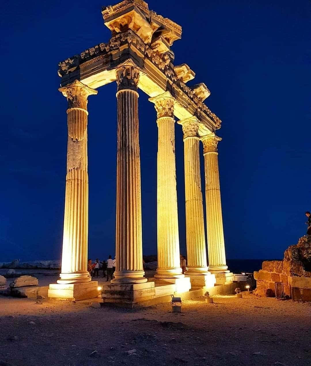 Temple Of Apollo Is Exceptionally Beautiful At Night Background