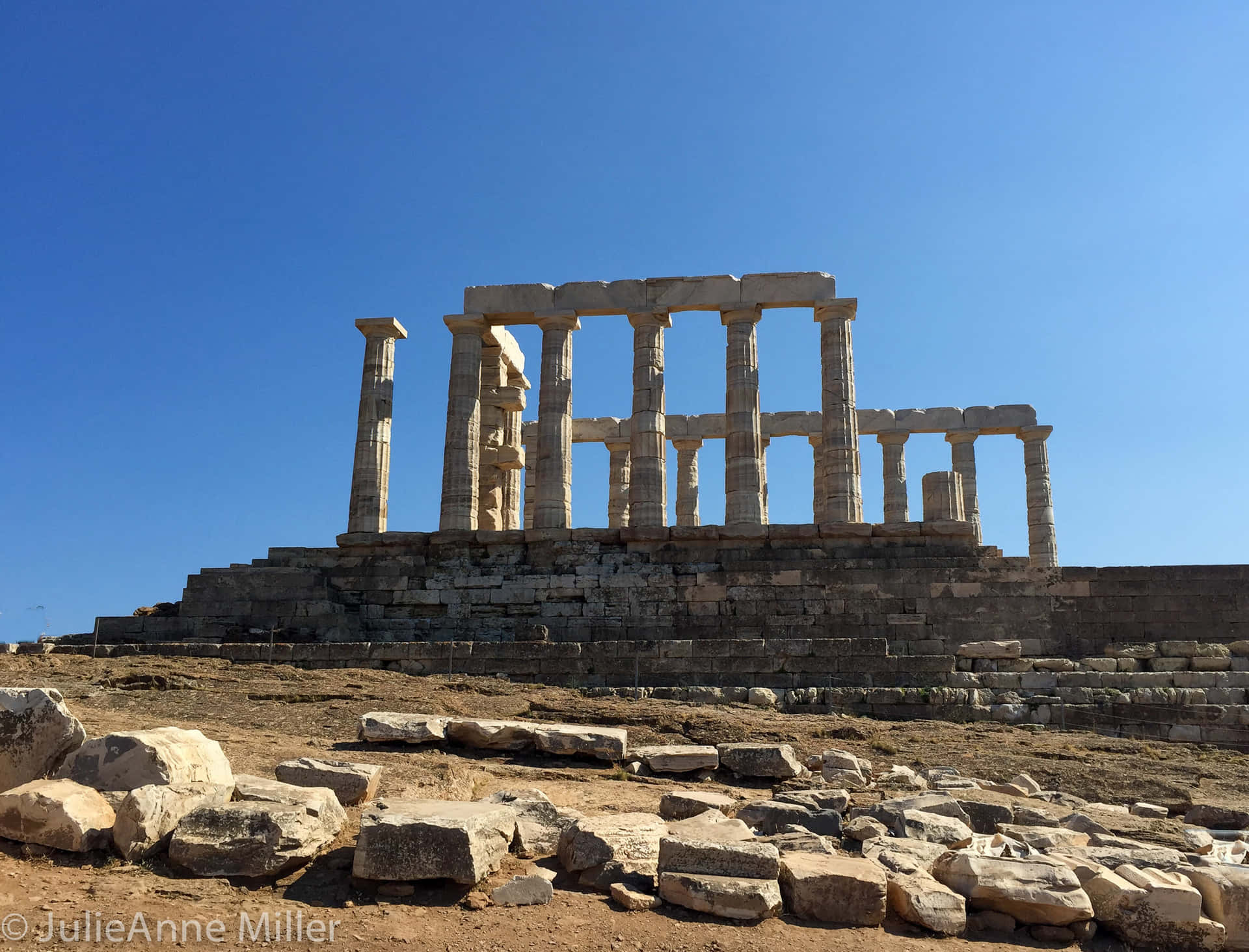 Temple Of Poseidon On A Cliff Background