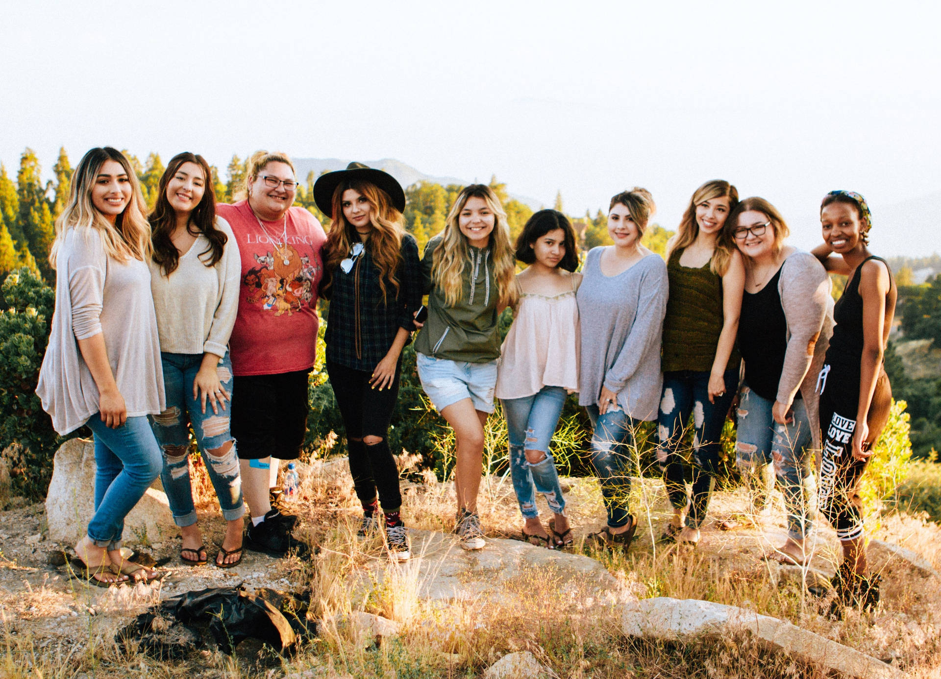 Ten Teenage Girls Posing Together Background