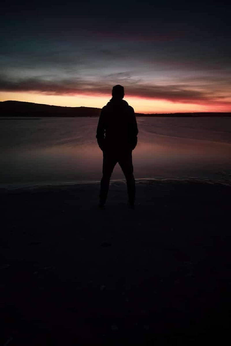 Tenacious Man Standing Peacefully Background