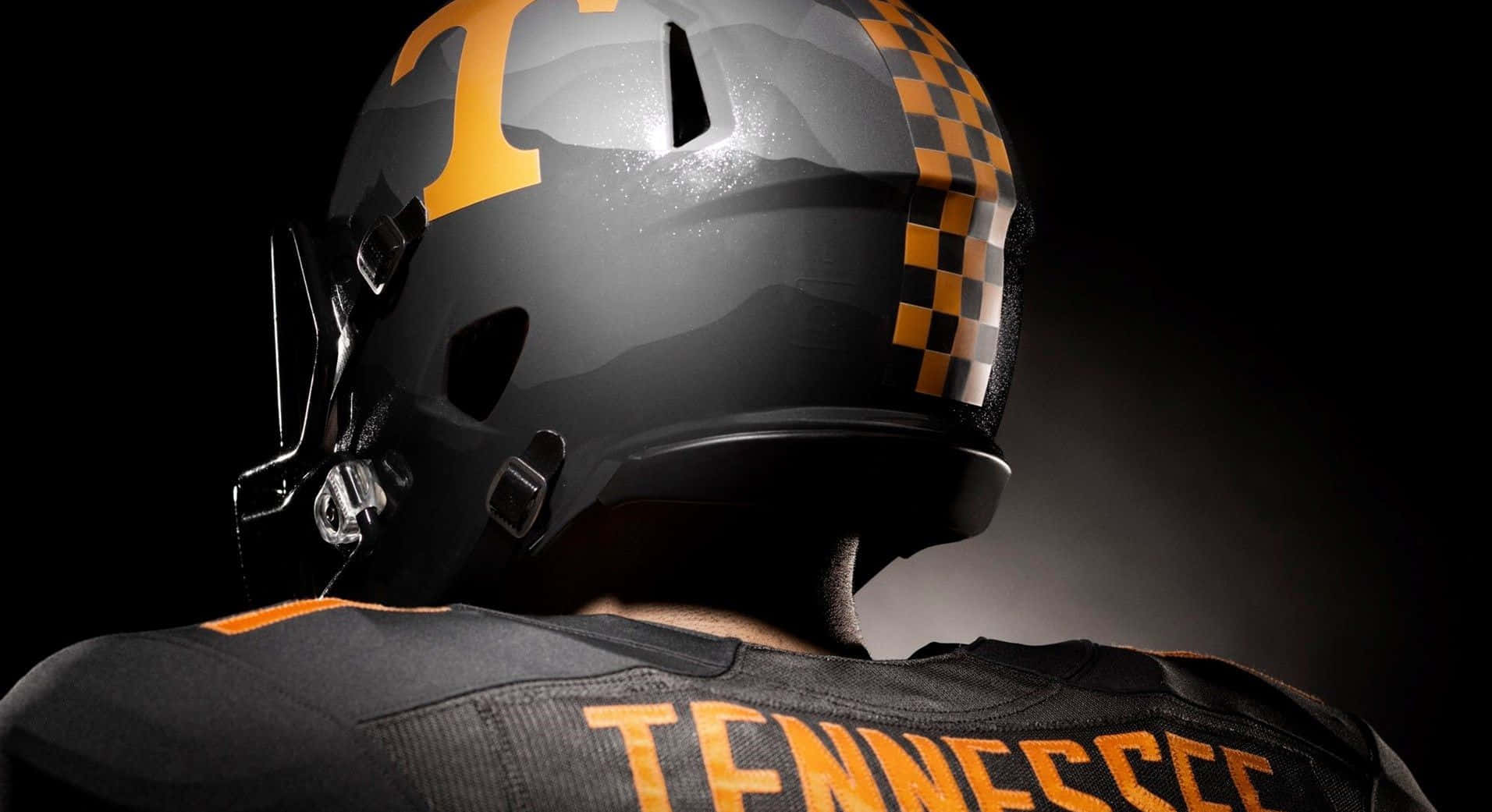 Tennessee Football Helmet With A Black And Orange Design Background