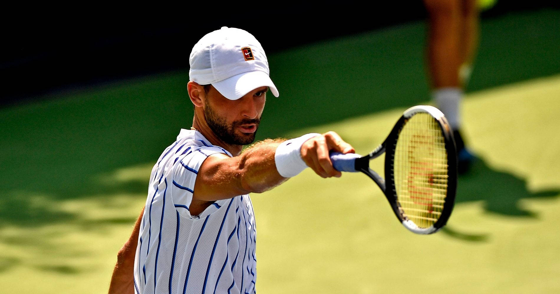 Tennis Champion Grigor Dimitrov In Action Background