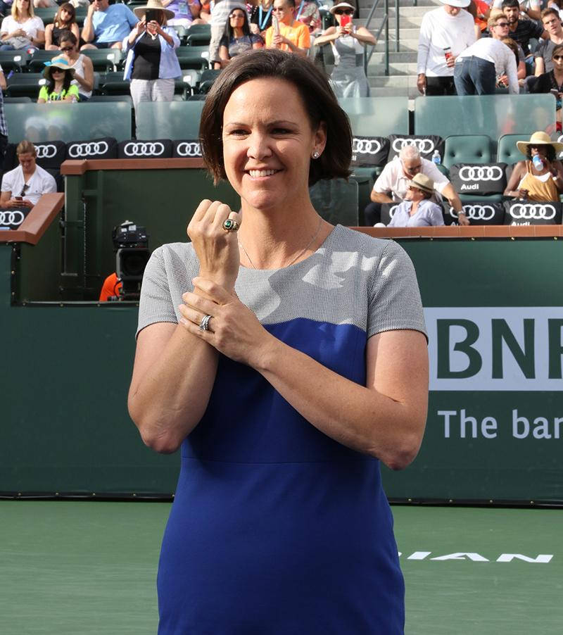 Tennis Champion Lindsay Davenport, Holding Her Wrist After A Powerful Swing. Background