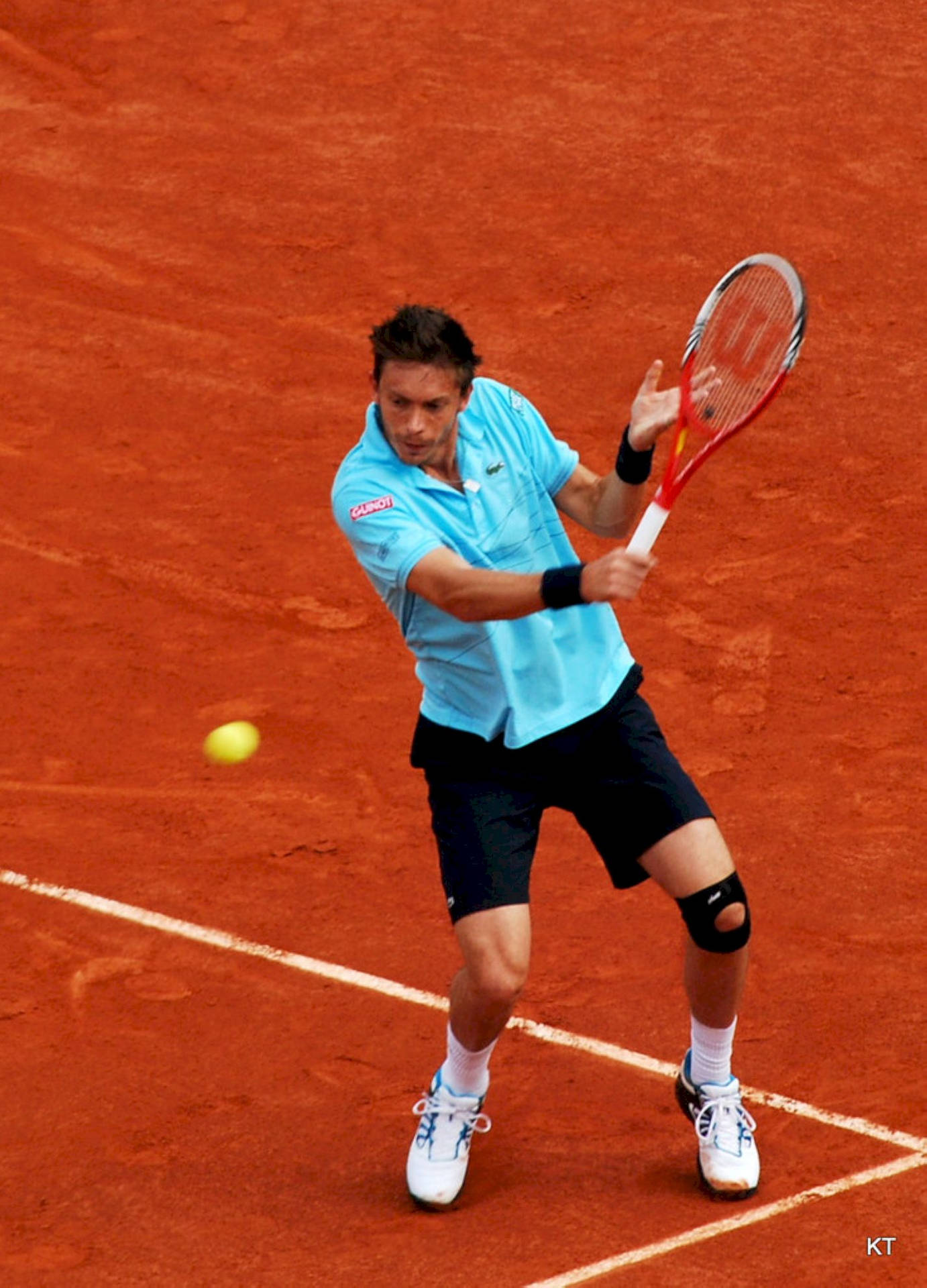 Tennis Champion Nicolas Mahut Exhibit Superior Skills On Orange Court Background