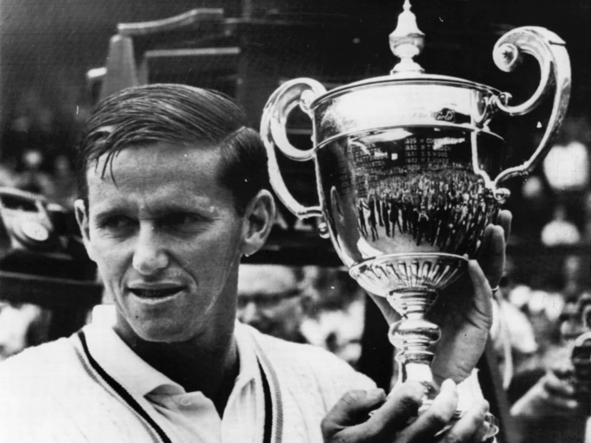 Tennis Champion Roy Emerson With Trophy Background