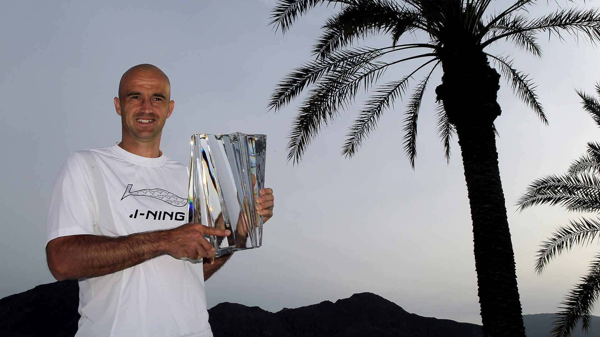 Tennis Champion With Trophy Under Palm Trees