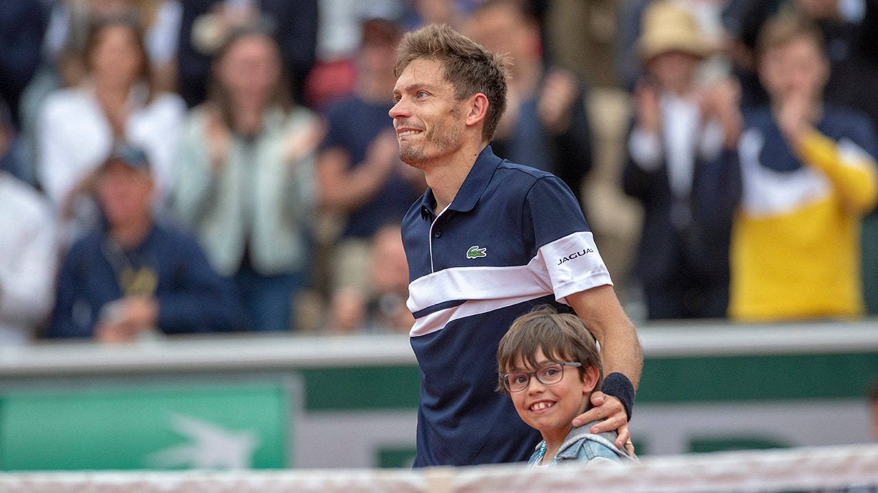 Tennis Legend, Nicolas Mahut, Celebrates Victory With His Son On Court Background