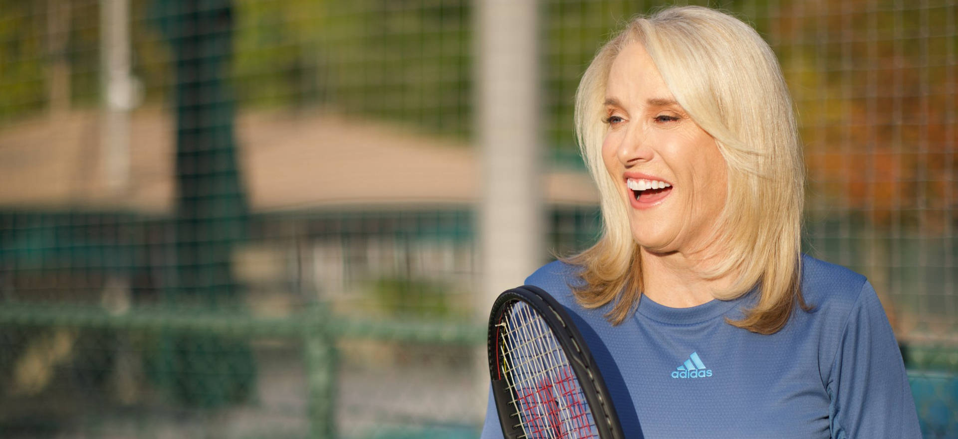 Tennis Legend Tracy Austin Poised With Tennis Racket Background