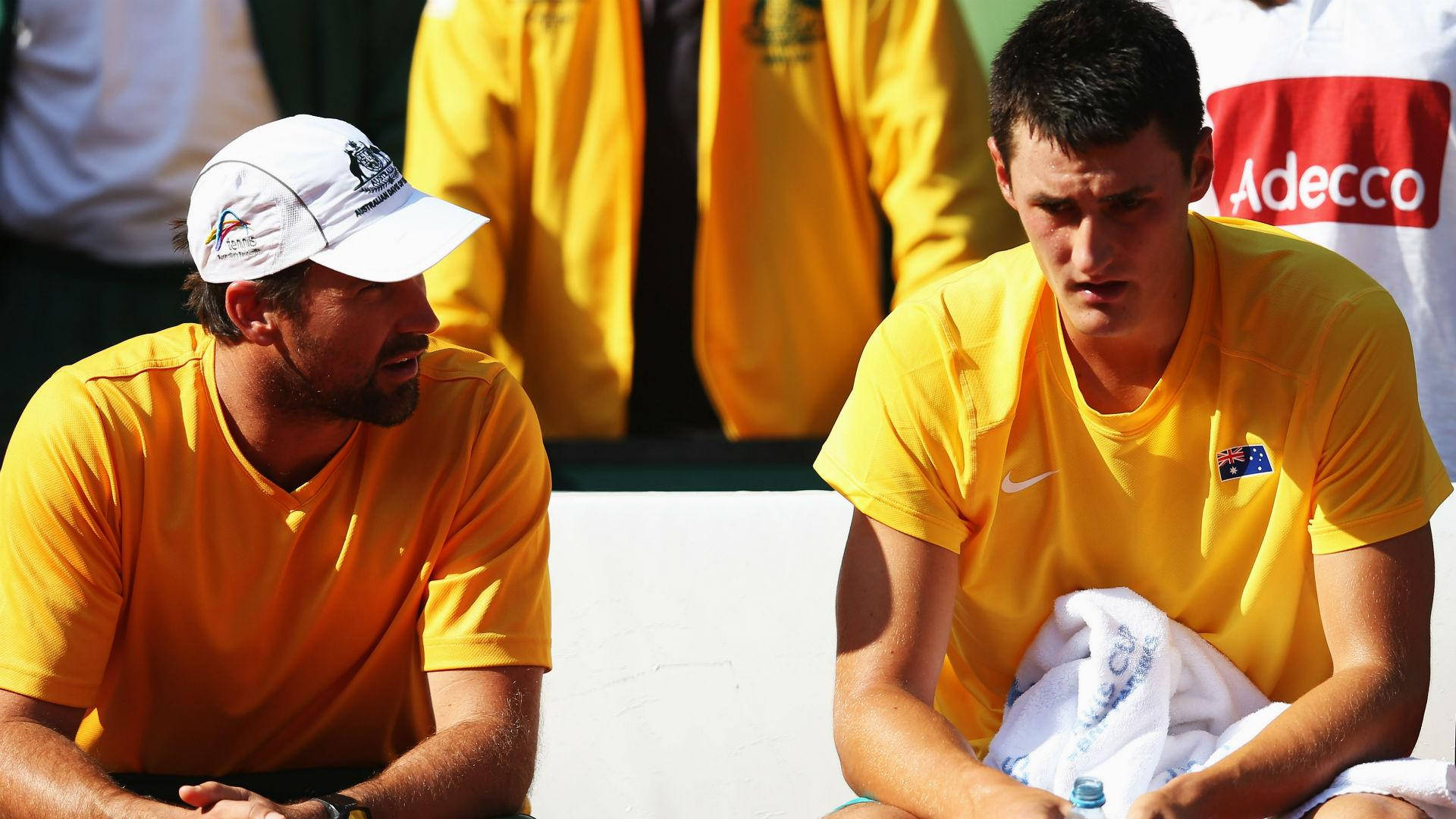 Tennis Legends - Patrick Rafter And Bernard Tomic In Candid Discussion On The Court Background