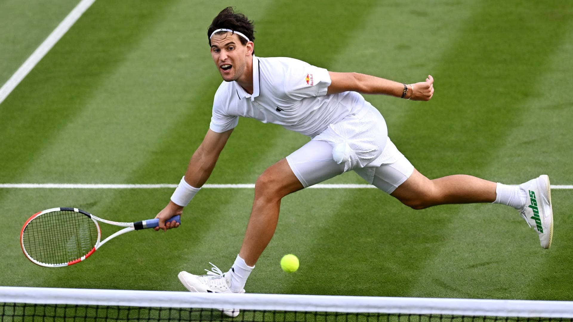Tennis Player Stretchingfor Ballon Grass Court Background