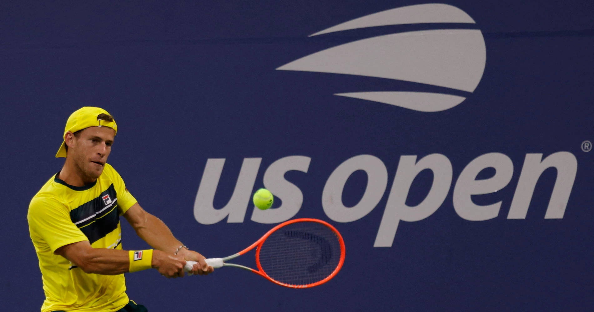 Tennis Pro, Diego Schwartzman In Action In Yellow Attire Background