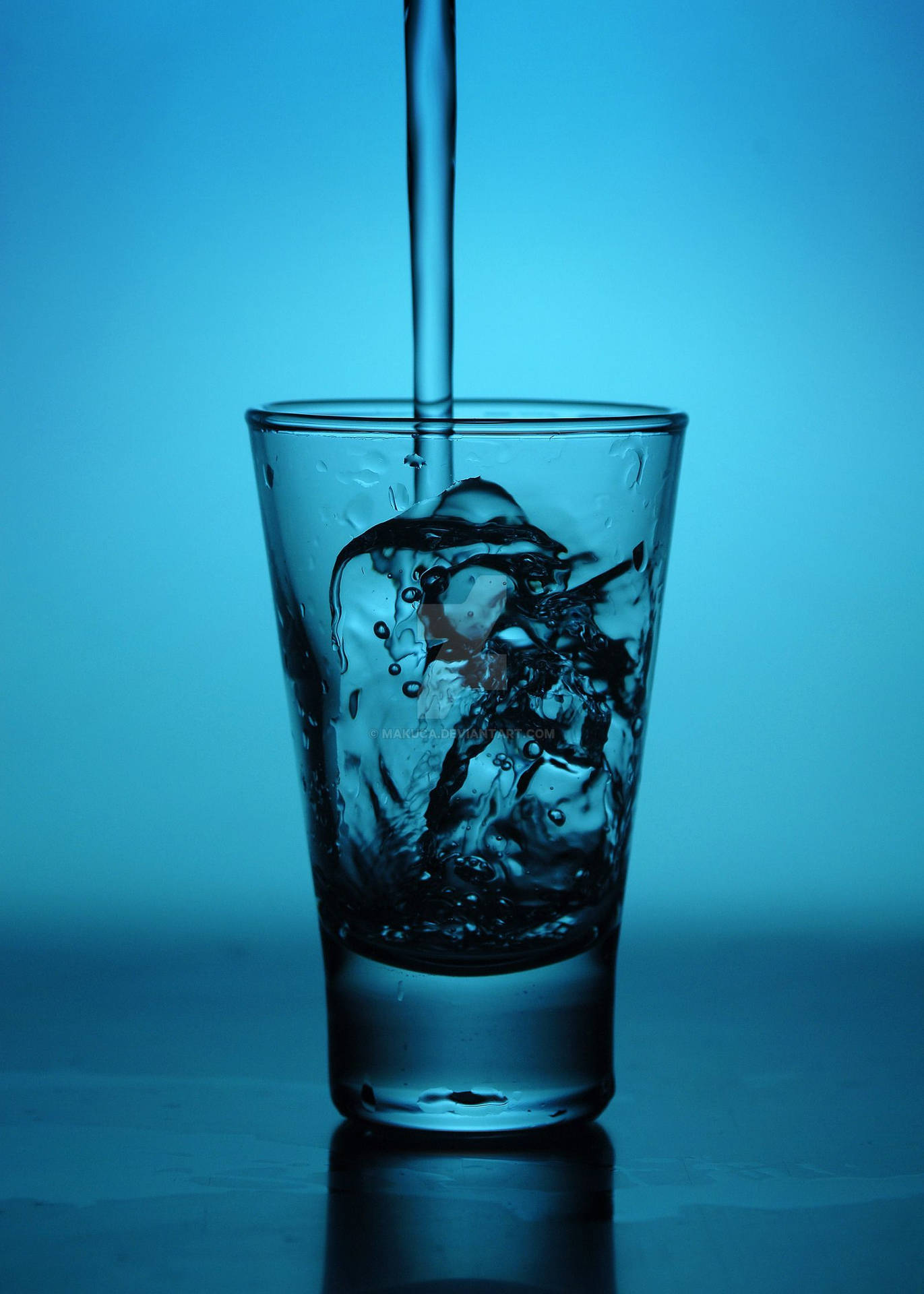 Tequila Pouring On Blue Glass Background