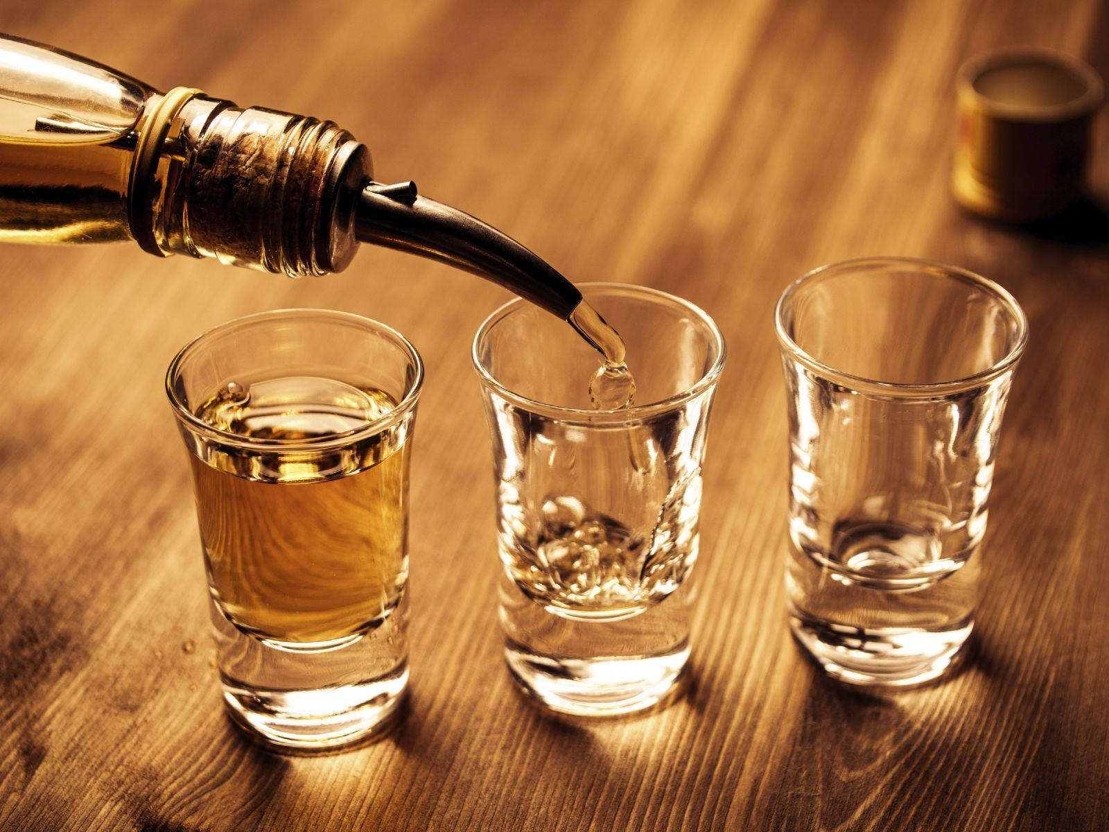 Tequila Pouring On Shot Glass Background