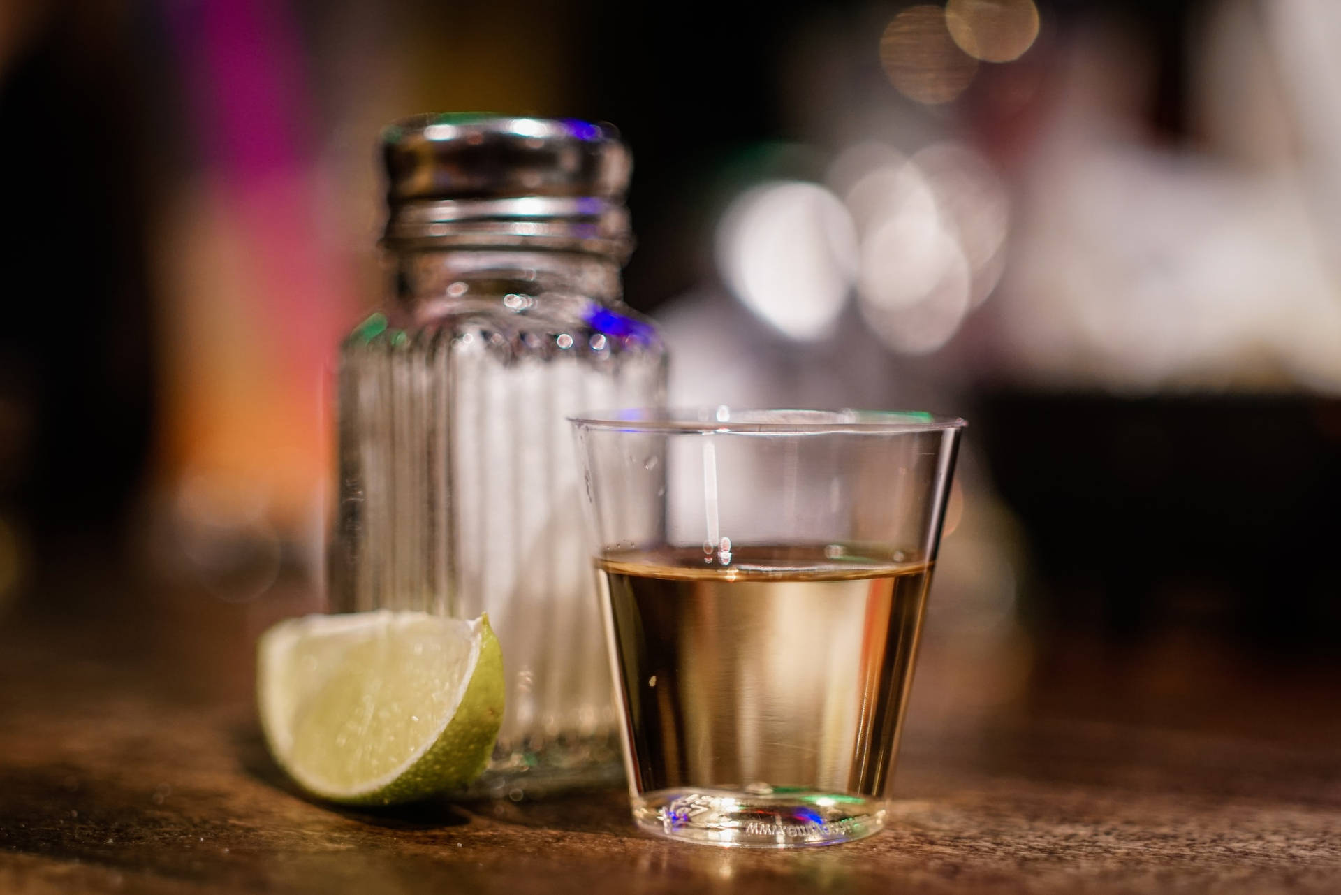 Tequila Shot With Lime Slice And Saltshaker Background