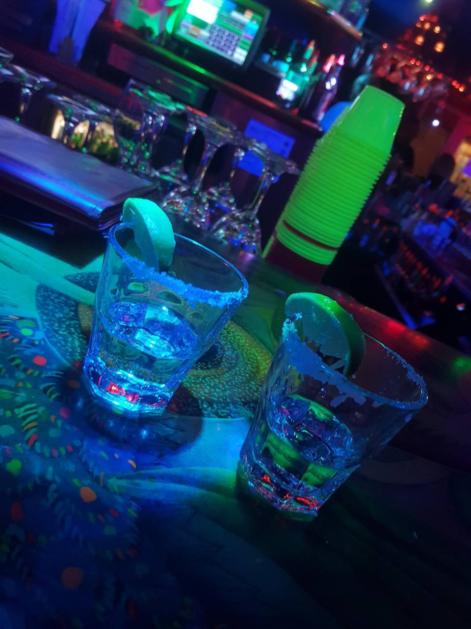 Tequila Shots On Bar Counter With Blue Lights Background