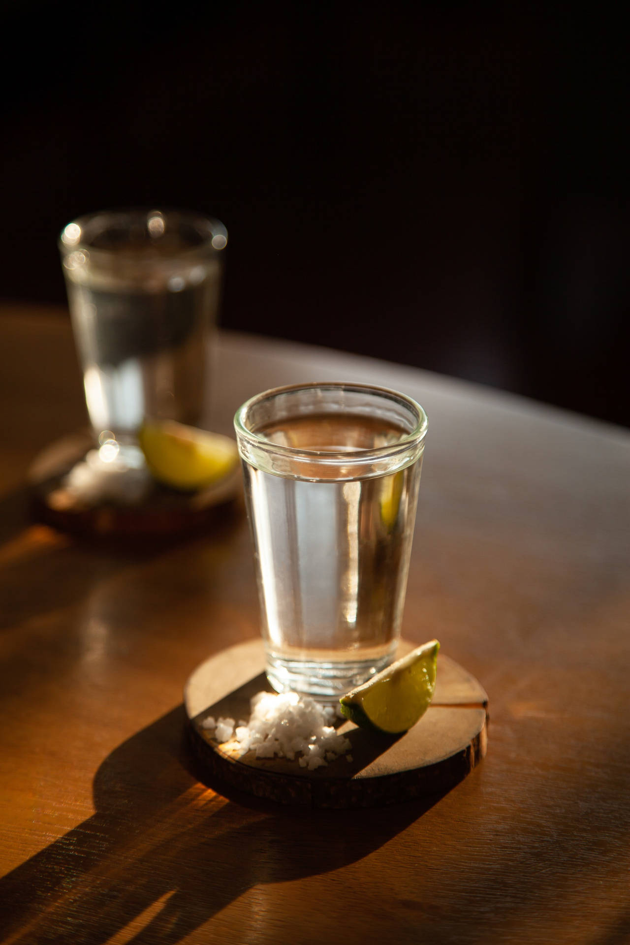 Tequila Shots On Wooden Coasters Background