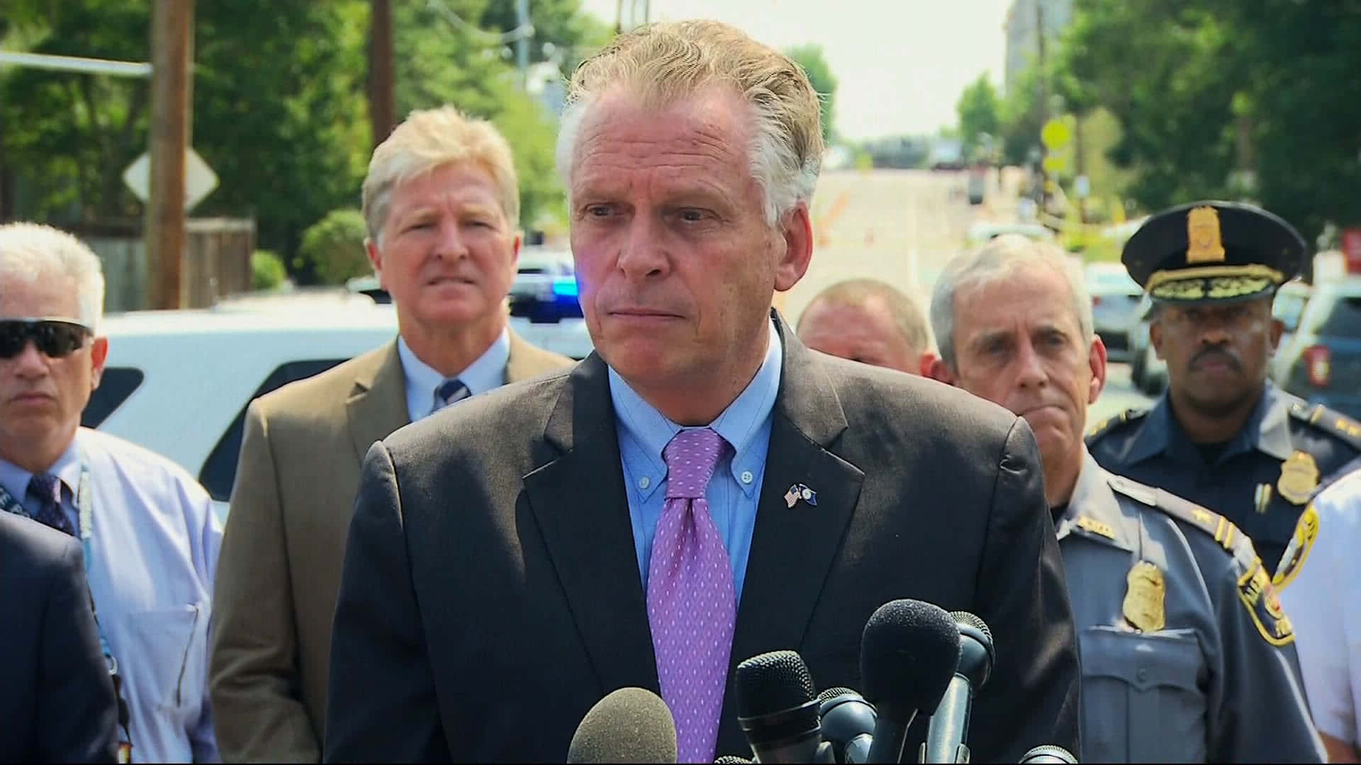 Terry Mcauliffe Articulating His Views Through Microphones. Background