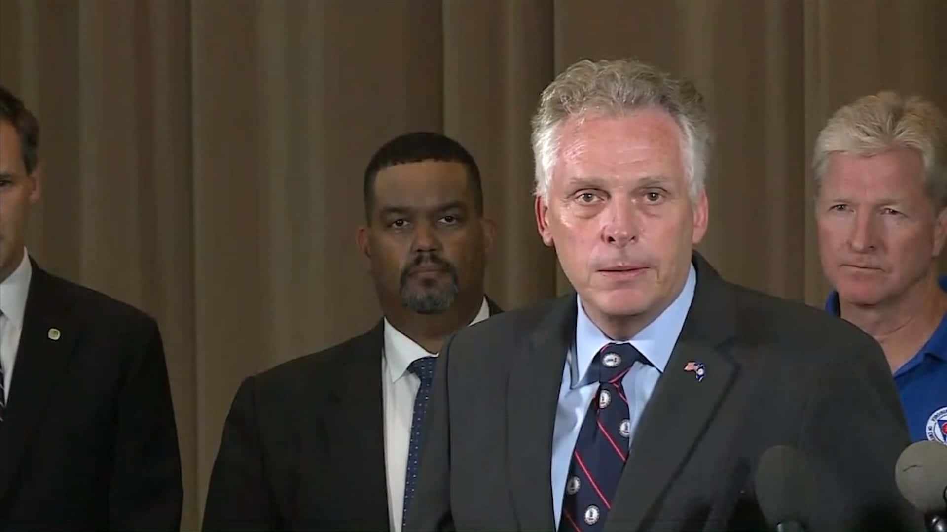 Terry Mcauliffe Delivering A Speech Background