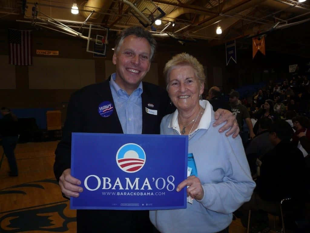Terry Mcauliffe Holding Obama 2008 Sign Background