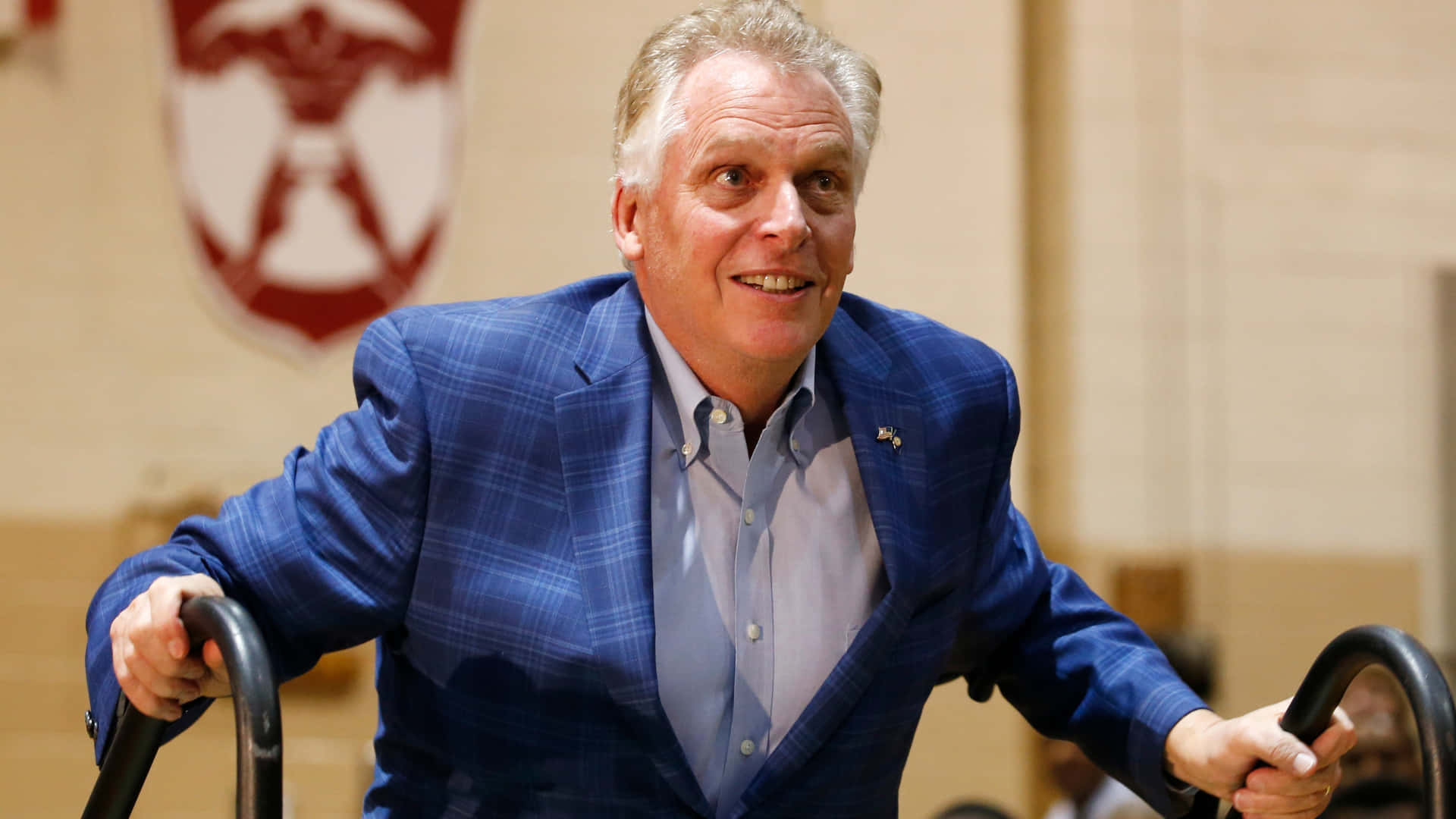 Terry Mcauliffe Walking Up To A Stage Background
