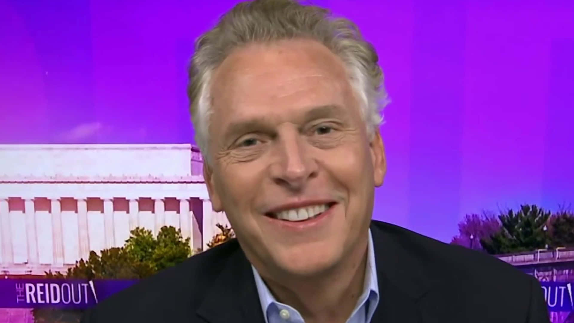 Terry Mcauliffe With A Purple Background Background