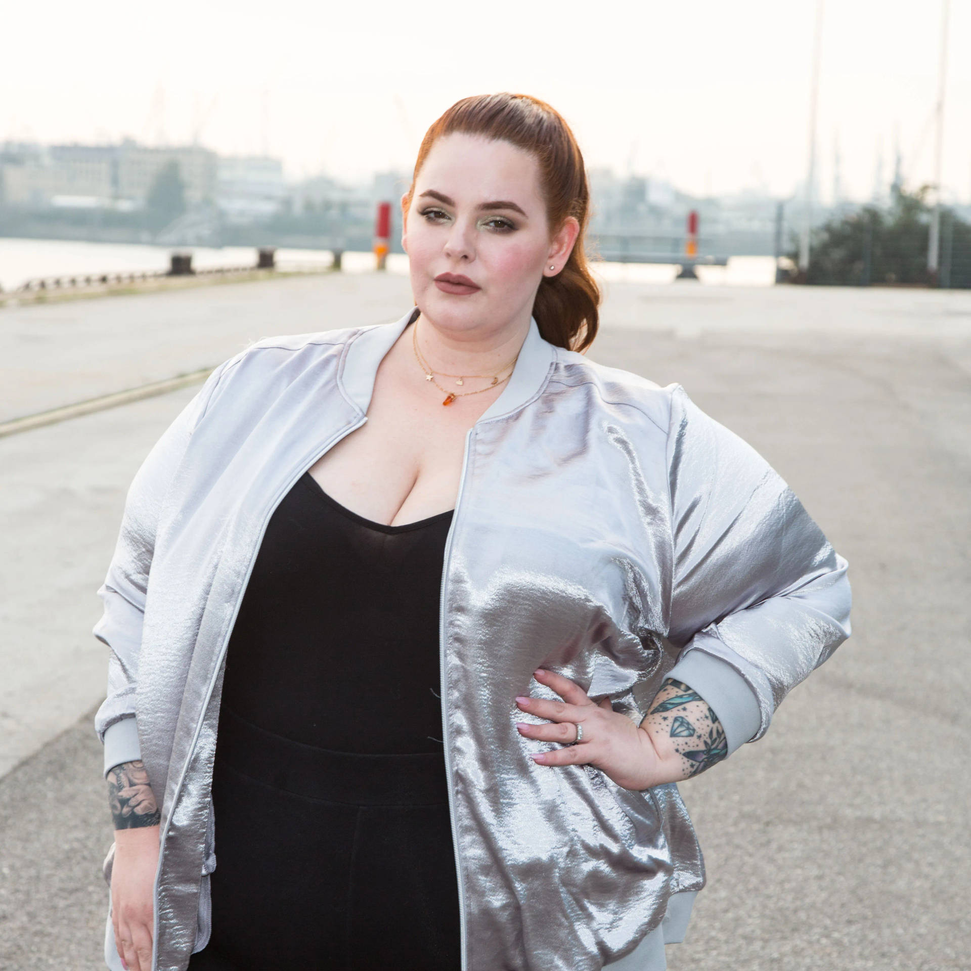 Tess Holliday Radiating Positivity In Silver Jacket Background