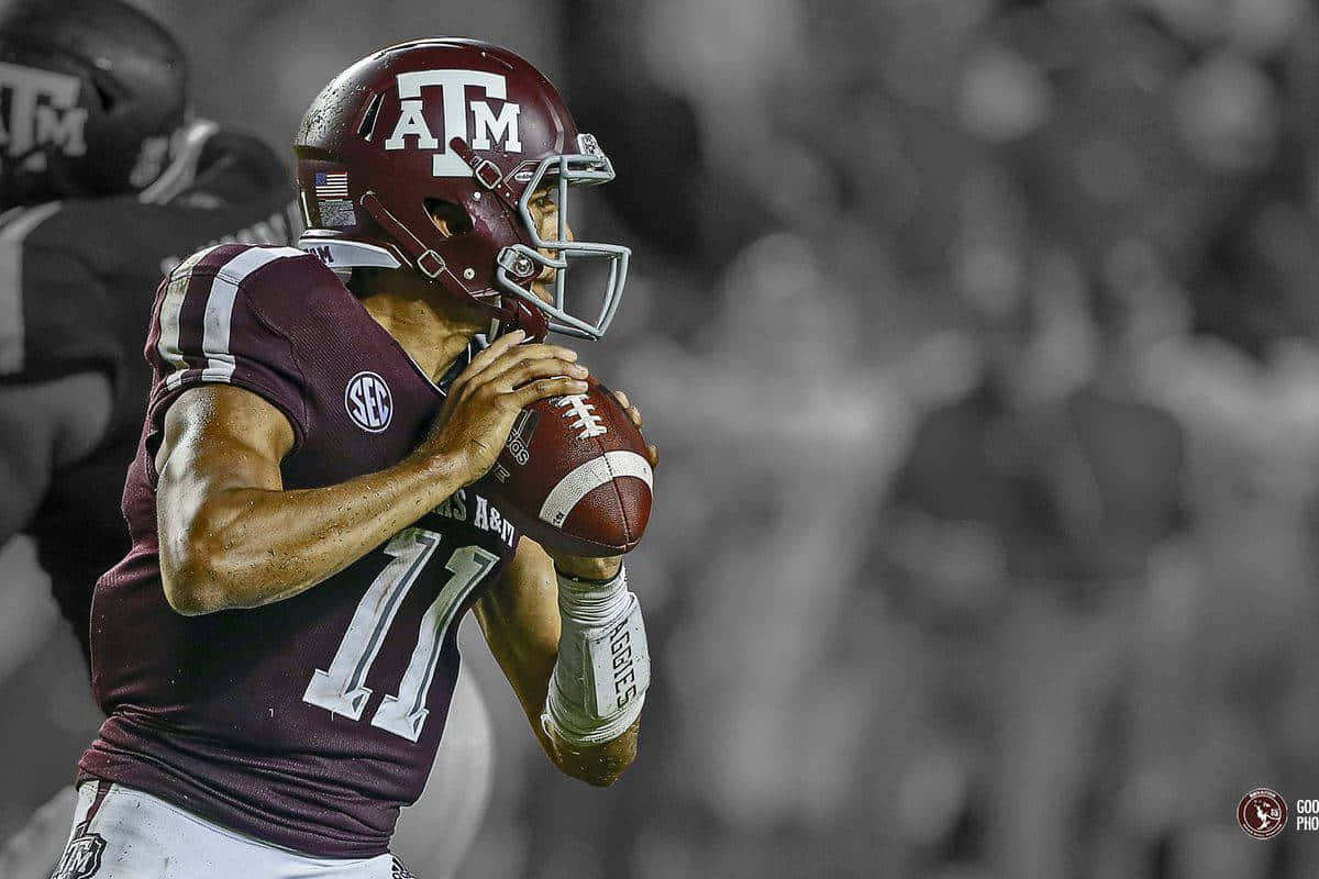 Texas Am Football Player Is Holding A Ball