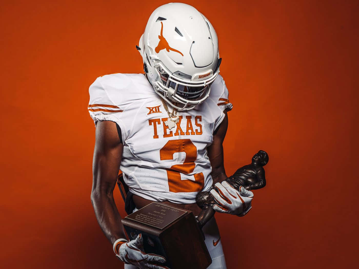 Texas Football Holding Trophy Background