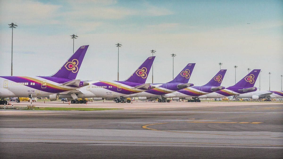 Thai Airways Airplanes On Airport Background