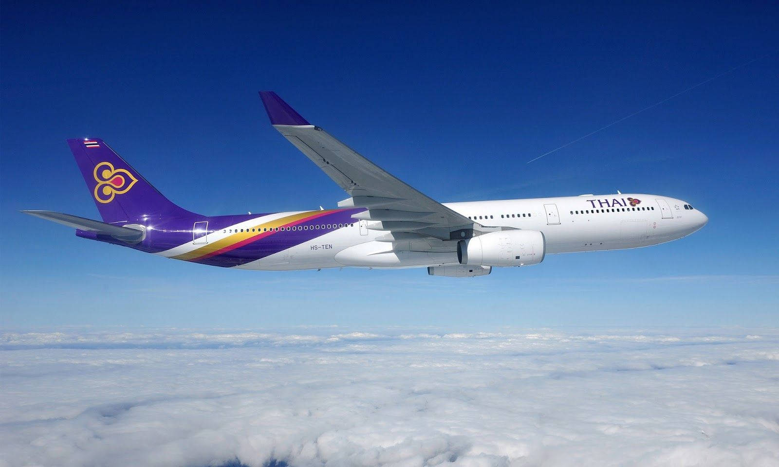 Thai Airways Plane Above Clouds Background