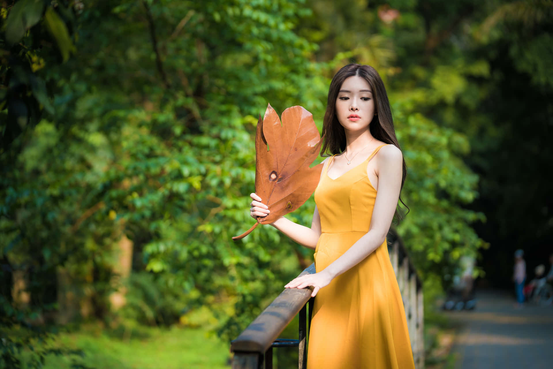 Thai Girl Posing With Large Leaf Background