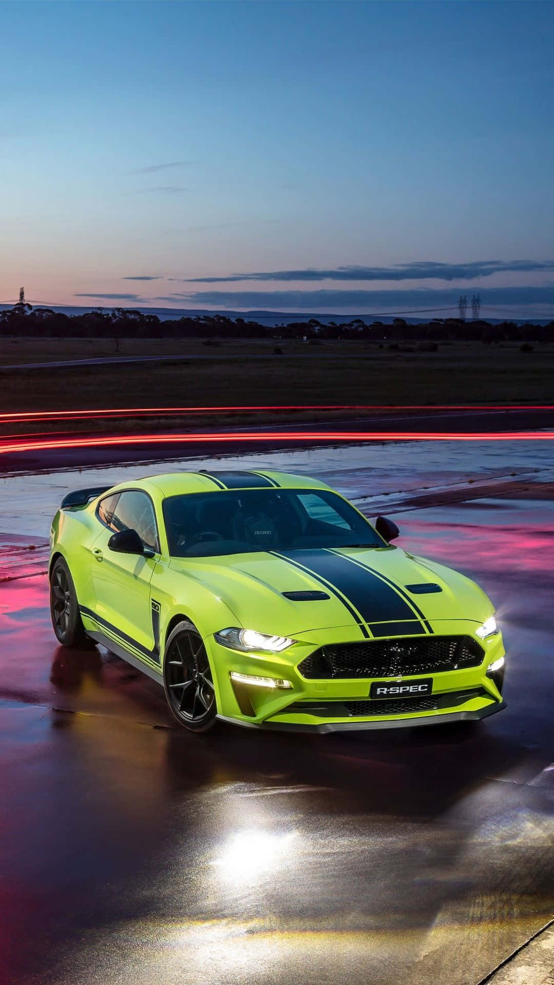 The 2019 Ford Mustang Gt Is Driving On A Wet Road Background