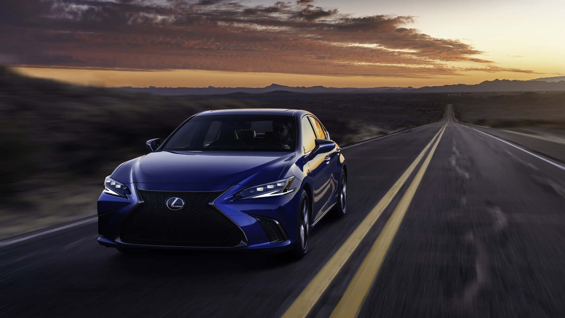 The 2019 Lexus Cs Driving Down A Road At Sunset