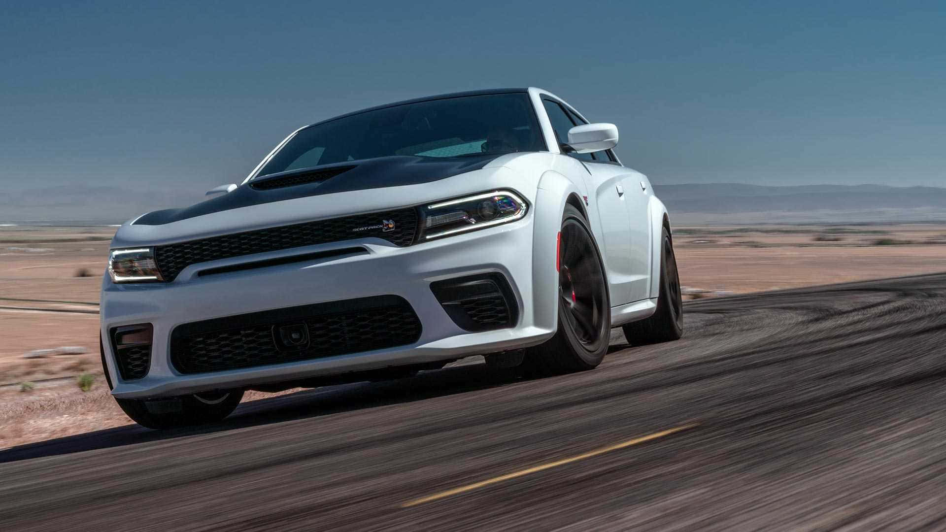 The 2020 Dodge Charger Srt Is Driving On A Desert Road Background