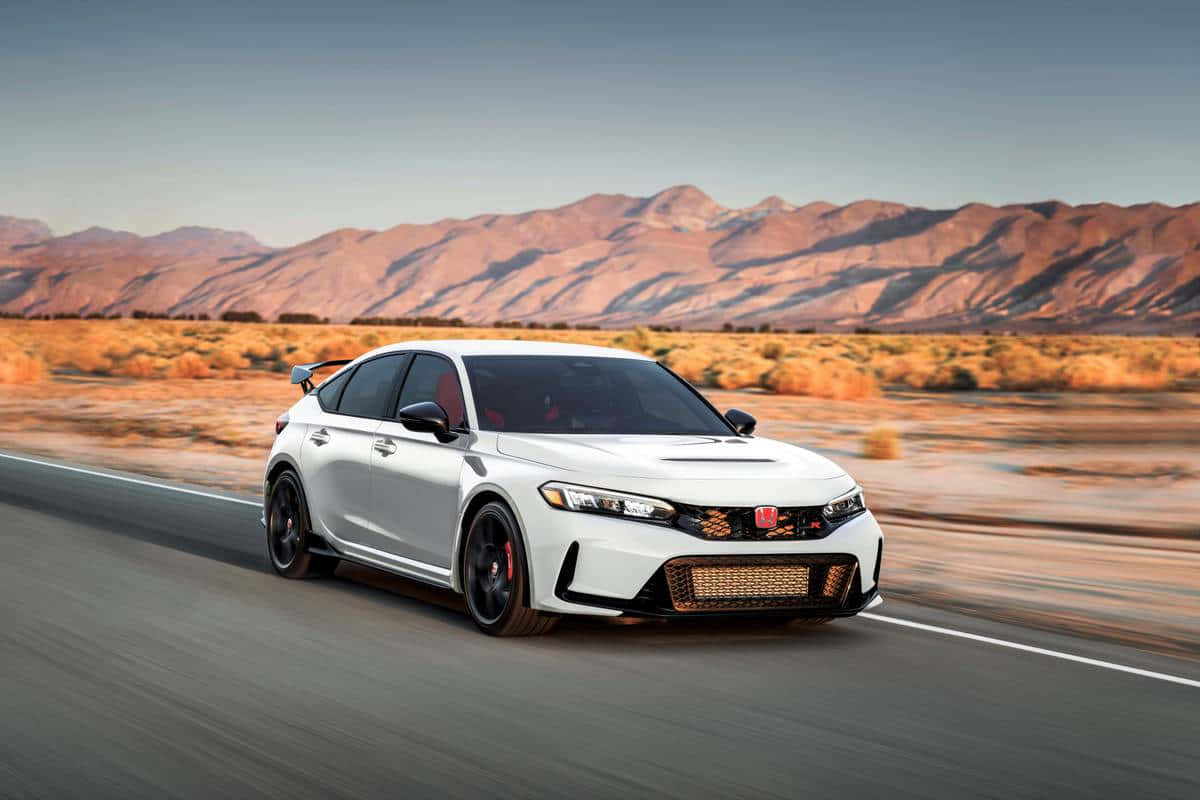 The 2020 Honda Civic Rsx Is Driving Down The Road Background